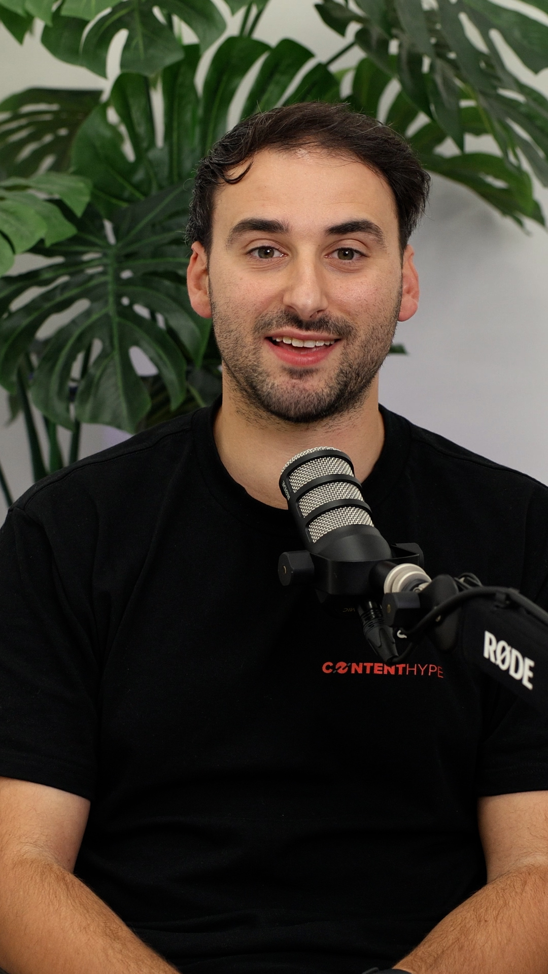 Matt Galea, Content Hype founder, mid-interview at the Essendon studio with Rode PodMic and monstera backdrop